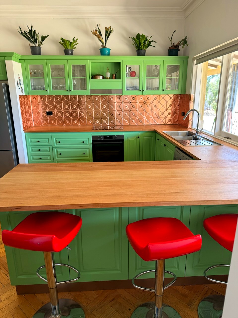 Renovated kitchen, sage green cabinetry, copper splashback and timber benchtops