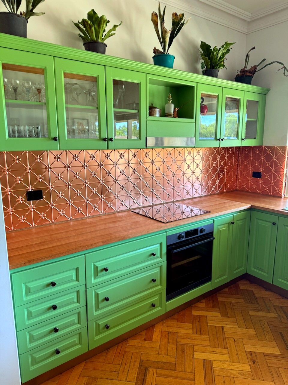 Renovated kitchen, pressed copper splashback and green cabinetry